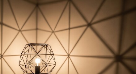 Fototapeta premium Geometric shadow pattern from modern wireframe lamp on wall