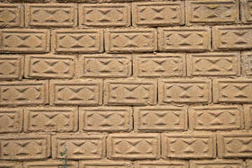 Wall made of tan bricks.
