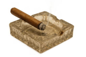 Lit cigar resting on a square stone ashtray with transparent background