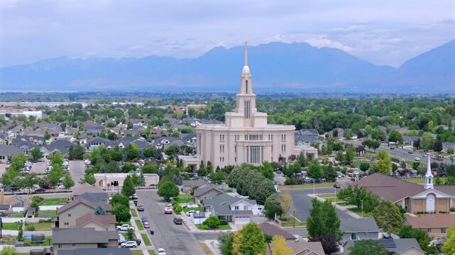Aerial footage showcases the grandeur of the Payson Utah Mormon Temple, highlighting its unique architecture amidst the serene rural landscape, enhancing its beauty and significance