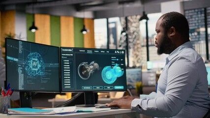 Engineer in office working on wind turbine component CAD design using artificial intelligence. African american man doing digital modeling of wind energy generator part using AI, camera B - Powered by Adobe