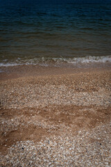 Shallow Waves Meet Pebbles and Shells on Calm Shore