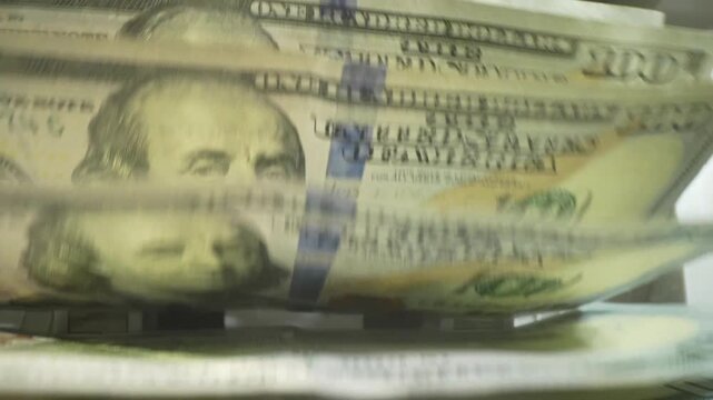 Macro shot counter counting dollar bills. Money counting machine with 100 dollar banknotes. Bank currency and finance. Close up cash money dollars counting. Crisis business, inflation concept.