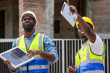 Two professional Black engineers collaborating on a building project. A skilled architect discusses...