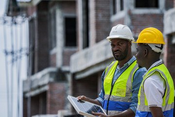 An experienced engineer teaches an apprentice about solar panel installation on a construction...