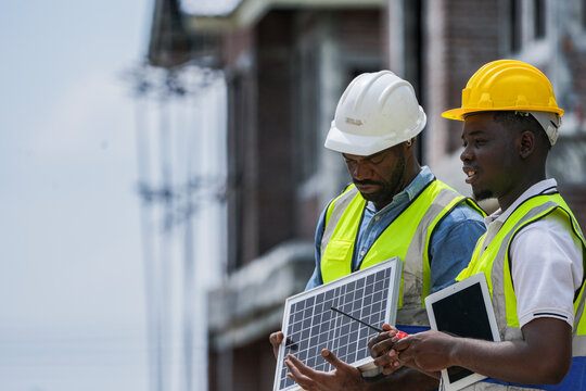 Black professionals collaborating on a renewable energy project. A senior engineer and his partner from a Black owned business discuss a solar installation, representing diversity in tech. - Powered by Adobe