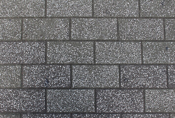Fototapeta premium Texture of gray square paving tile. Pattern of sidewalk tiles in the street. Concrete pavers close up background.