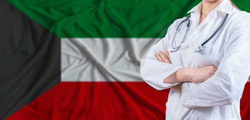 Doctor with crossed arms on Kuwait flag. Kuwait health and care concept. Female doctor on Kuwait...