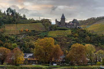 Photograph of a village while cruising along the Rhine River in Germany in the fall with a beautiful sky and fall colors