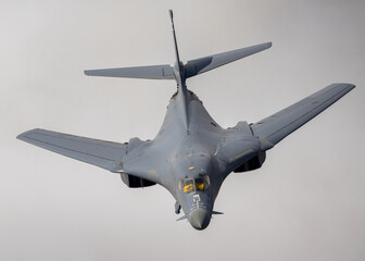 Very close top  view of a a B-1 Lancer  flying with wings in full sweep