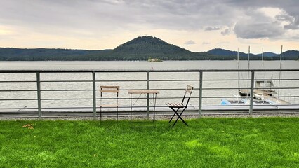 A Beautiful and Serene Lakeside View Featuring Tables and Chairs for Relaxation and Enjoyment