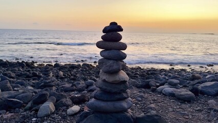A beautiful and serene Stone Tower stands tall at Sunset by the vast Oceans edge