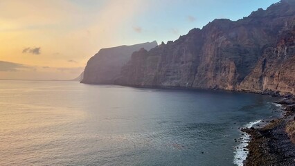 The breathtaking scenic coastal cliffs appear mesmerizing at sunset above the calm waters