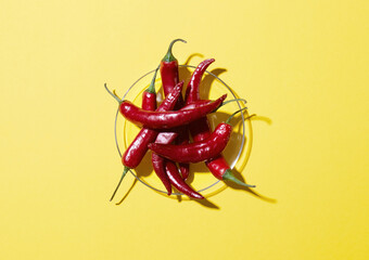 Many red chilli peppers on a yellow