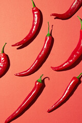 Many red chilli peppers on a red
