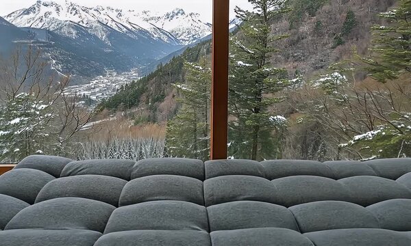 Snowy mountain view with gray futon