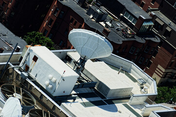 Satellite Dish and Rooftop Equipment on Urban Roof