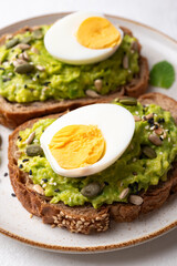 Avocado toast with boiled egg, sunflower seeds, pumpkin seeds and sesame seeds, Healthy eating