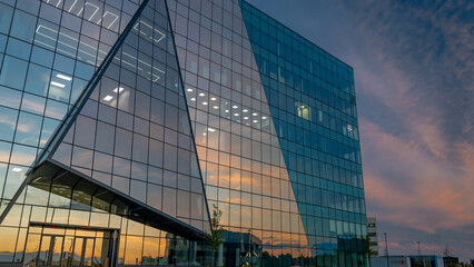 Lakewood, NJ, USA - August 27, 2025 - Large Modern Business Building with Sunset in Background and...