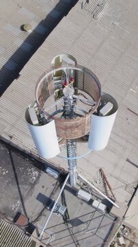 Monopole Cell phone tower Hidden antenna on a building in a small industrial area for mobile devices - antenna emitting non-unisang radioactivity near a residential area - Vertical video