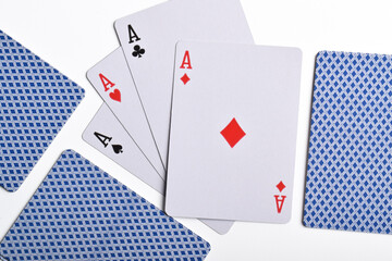 Four aces and other playing cards isolated on white, top view