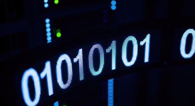 Binary code display panel with glowing blue, white, & green lights