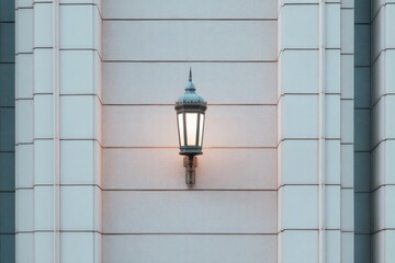 Illuminated lantern on pristine wall creates serene evening ambi