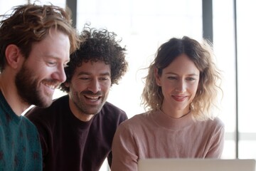 Obraz premium Three friends enjoy lighthearted moment while collaborating on p