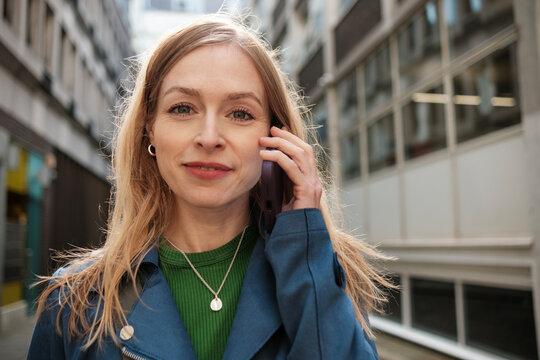 Businesswoman talking on phone in city street