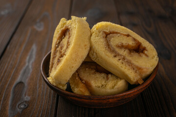 Cinnamon Roll Cake Slices on Rustic Wooden Table - Authentic Dessert Presentation