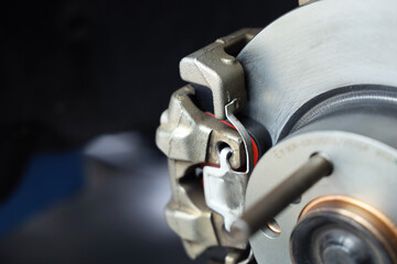 maintaining car wheel brake disc at repair service station.