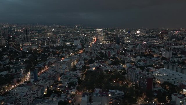 An illuminated and calm Mexico City at night, captured by a drone