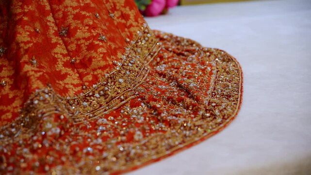 Bottom of red color wedding dress on the traditional Asian wedding , Slow movement camera shote.