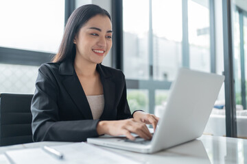 Beautiful&nbsp;confident asian business woman working with laptop Hands typing  keyboard. Professional investor working new start up project. business planning in office. Technology business