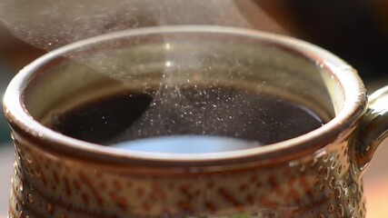 steaming hot coffee mug falling sugar particles - Powered by Adobe