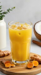 Golden turmeric drink with ice in glass