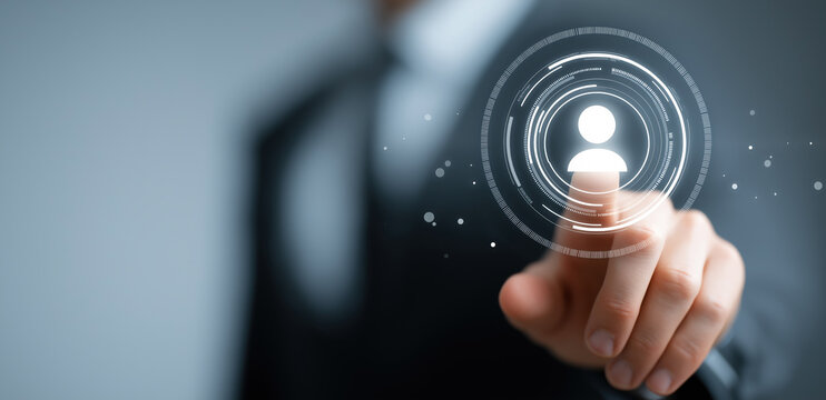 Hand extends toward illuminated circular digital interface element.