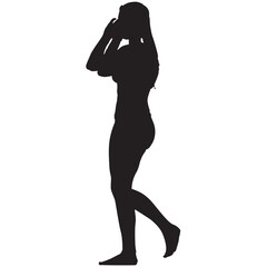 Fototapeta premium A silhouette of a woman walking barefoot in a bikini