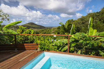Elegant poolside view offering a stunning landscape and lush green scenery.