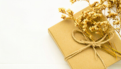 Rustic Gift with Dried Blooms: A beautifully wrapped package adorned with a delicate twine bow and rustic dried flowers, creating a visual of elegance and natural charm.
