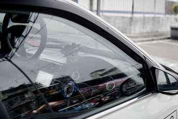 Fototapeta premium Close-Up of White Car Side Window with Reflections