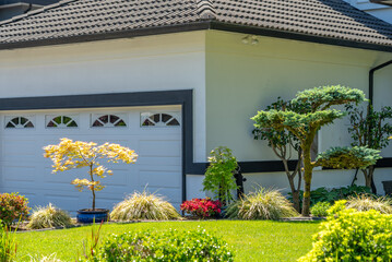 Garage door in luxury house with trees and nice landscape in Summer in Vancouver, Canada, North...
