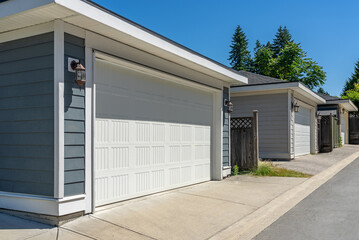 Garage door in luxury house with trees and nice landscape in Summer in Vancouver, Canada, North...