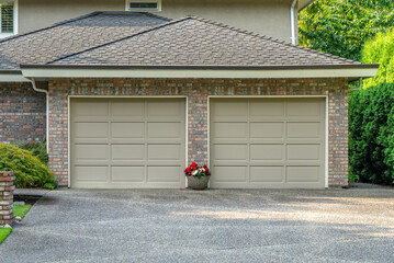 Garage door in luxury house with trees and nice landscape in Summer in Vancouver, Canada, North...