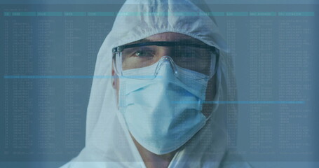 Laboratory technician analyzing log overlay in cleanroom, wearing hood coverall mask and goggles