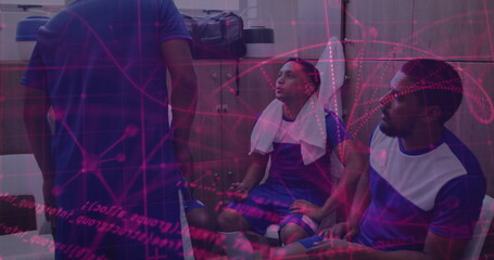 Catching breath soccer players wearing jerseys resting on bench in locker room, with wooden lockers
