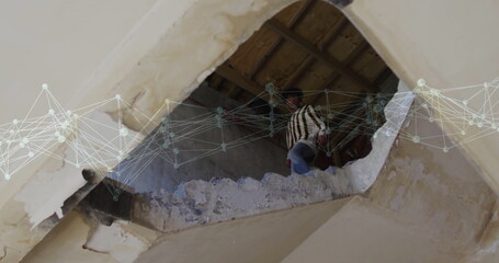 Climbing man gripping beam amid debris in damaged ceiling, with digital network overlay, copy space