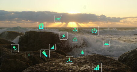 Crashing ocean wave smashing over jagged rocks on rocky coast at sunset, with eco icons overlay