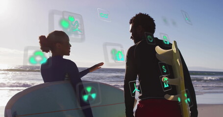 Gesturing surfers wearing wetsuits pointing to ocean on beach holding surfboards and data icons