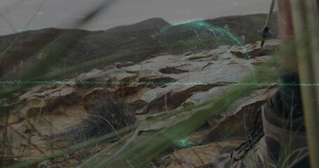 Projecting holographic overlay on hillside outcrop, near hiking boot and trekking pole, copy space